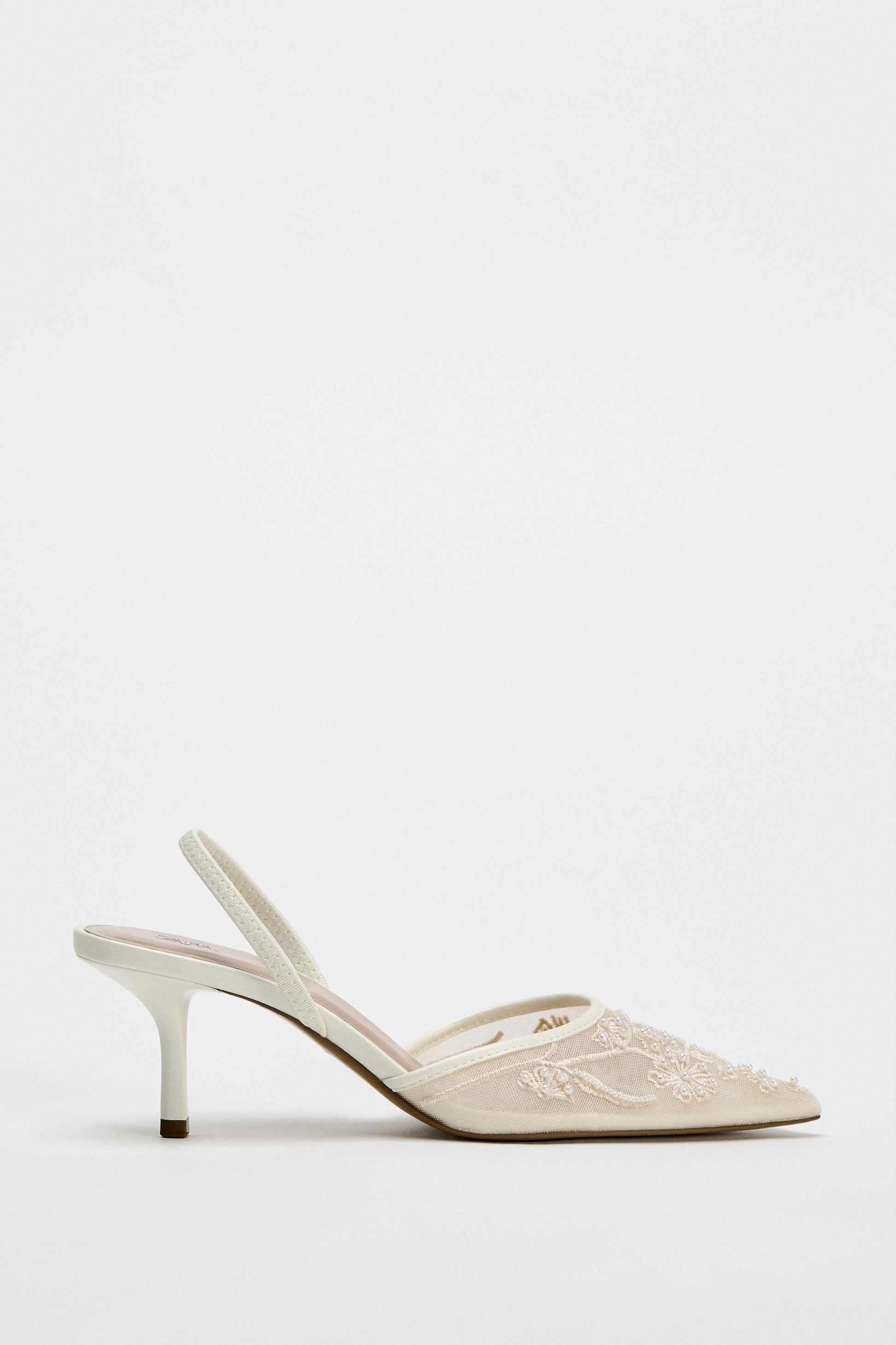 White high-heeled shoe with a subtle design on a white background