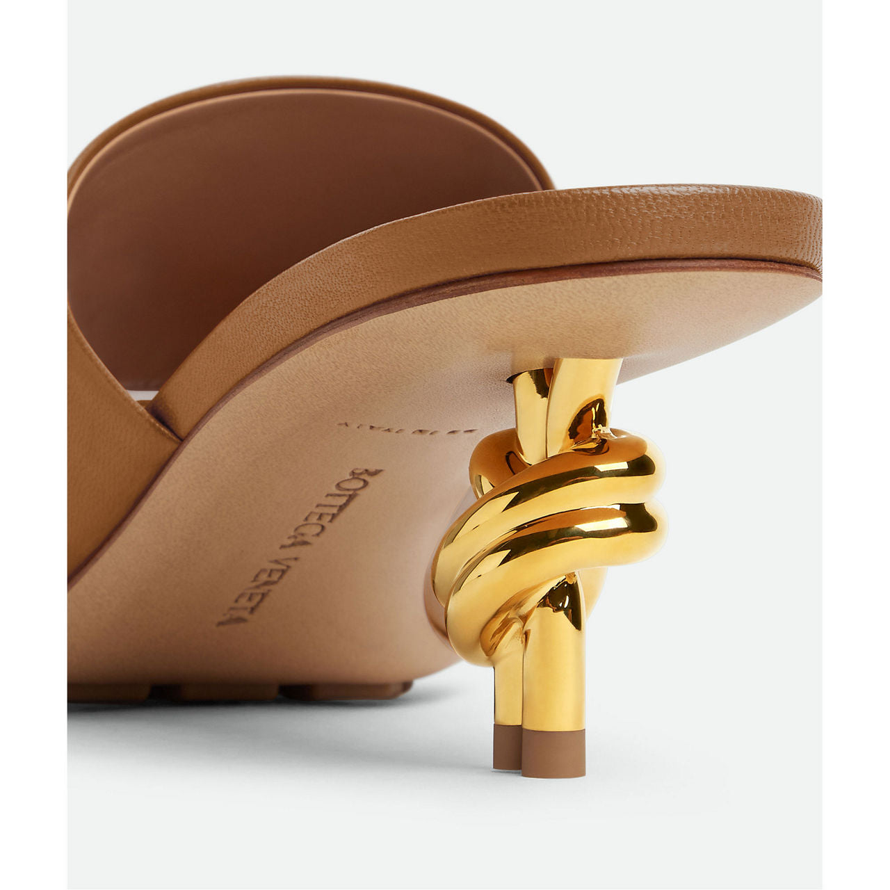 Mule with gold finished metal knot heel